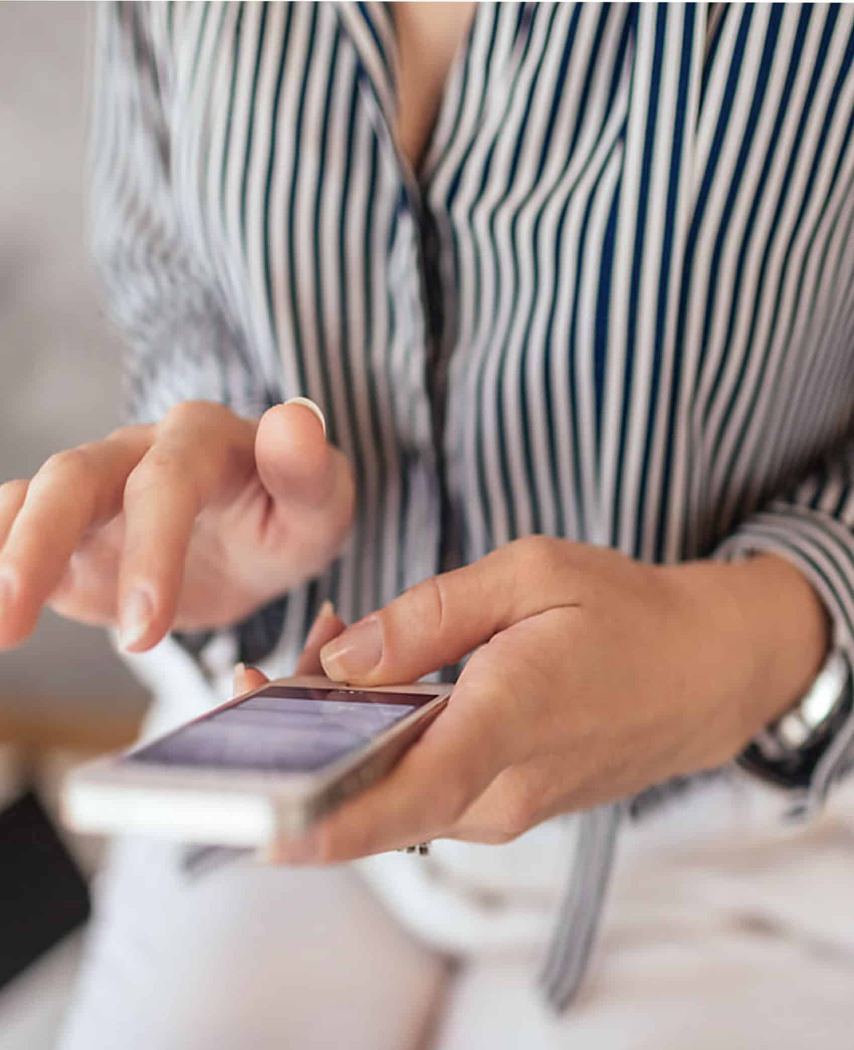 Smartphone user accessing digital marketing services at Prestige Digital for business growth and online success.
