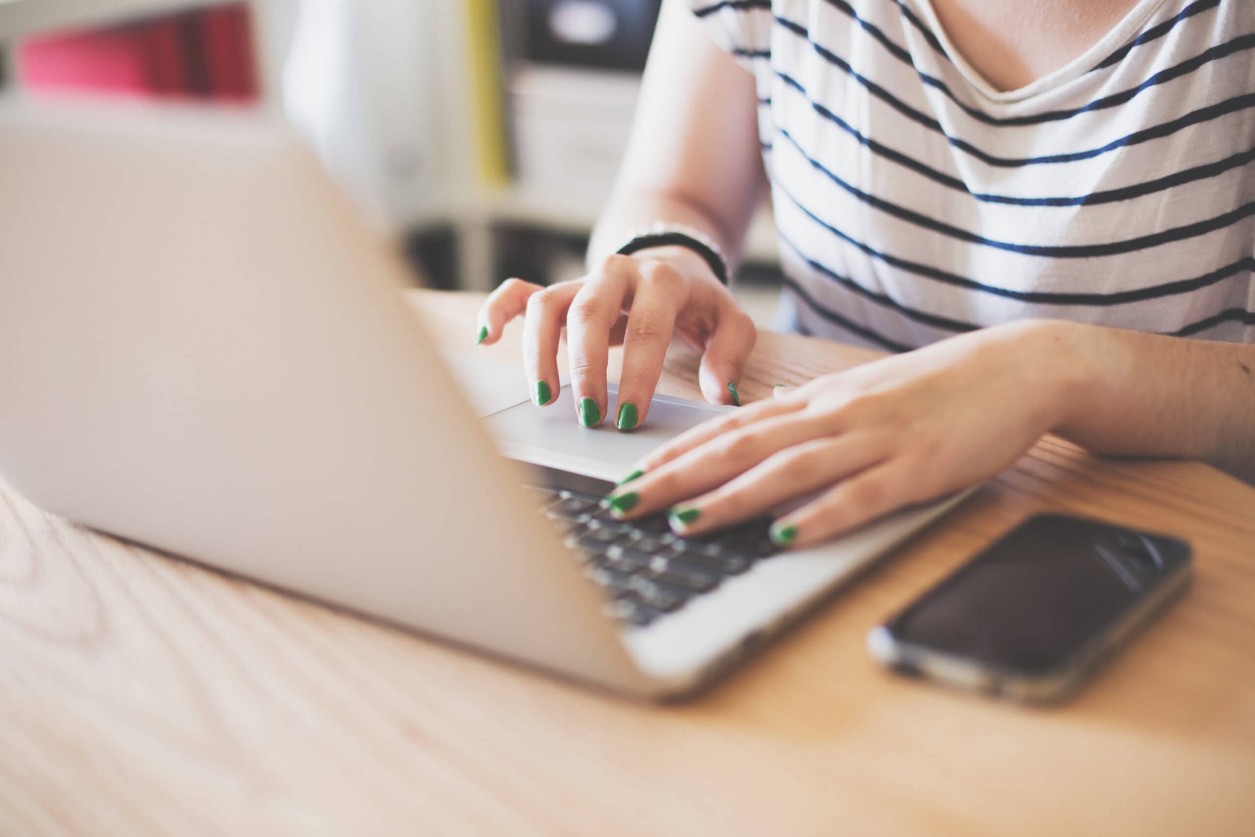 Laptop user typing at a desk, showcasing digital work and online presence for digital marketing and SEO strategies.